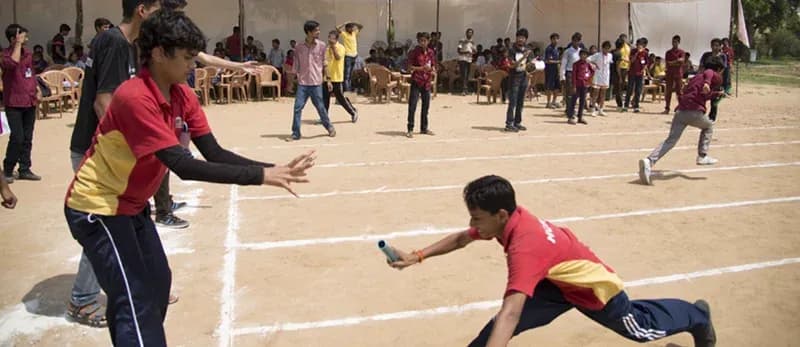 Children taking part in a sports day relay race